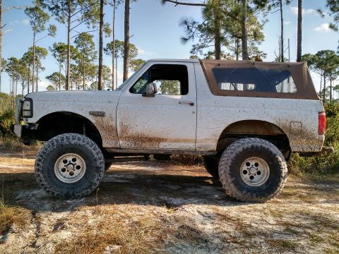 1992 Ford Bronco - This 1992 Ford Bronco is ready for off-road adventure, sporting large tires and a muddy exterior.