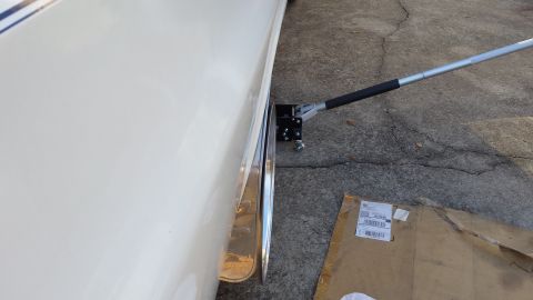 1976 Ford Ranchero - A car's wheel is elevated by a jack on a cracked concrete driveway, with a cardboard box nearby.