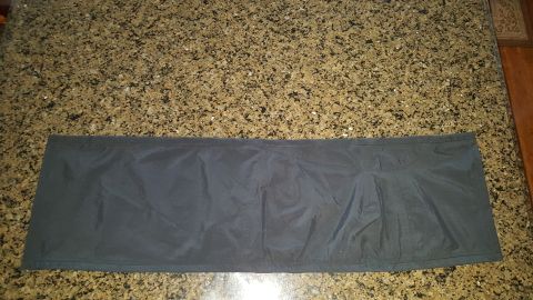 1996 Ford Bronco - A dark fabric mat lies flat on a speckled countertop.