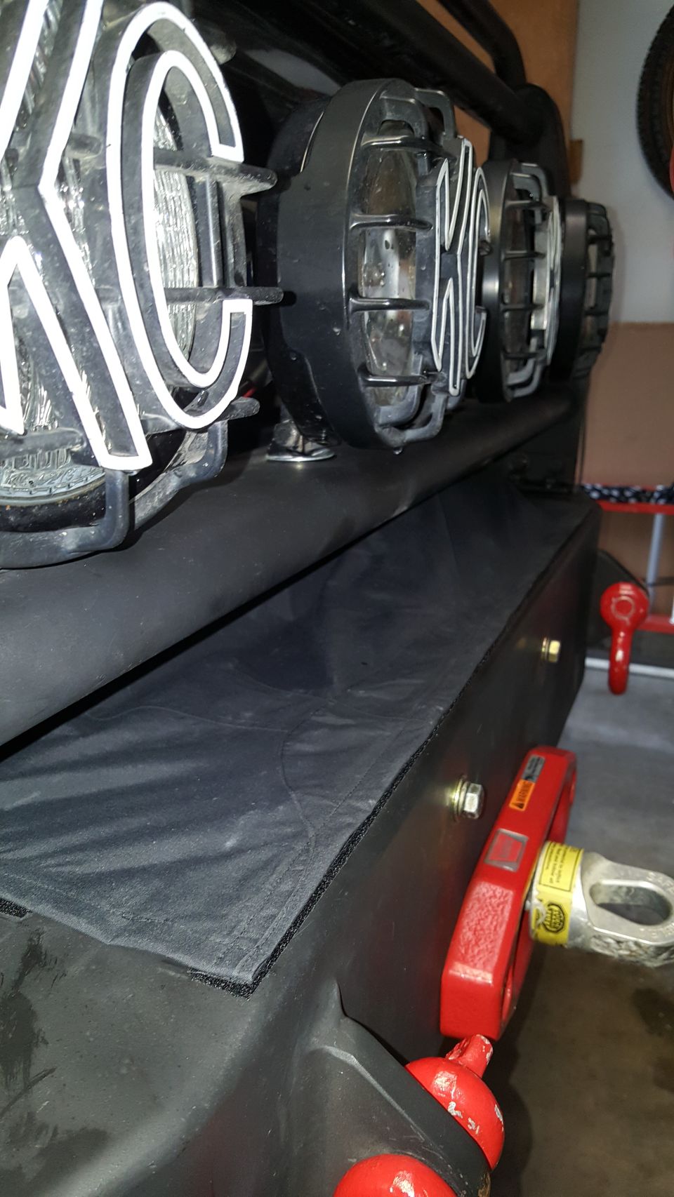 KC lights and red winch on a black bumper