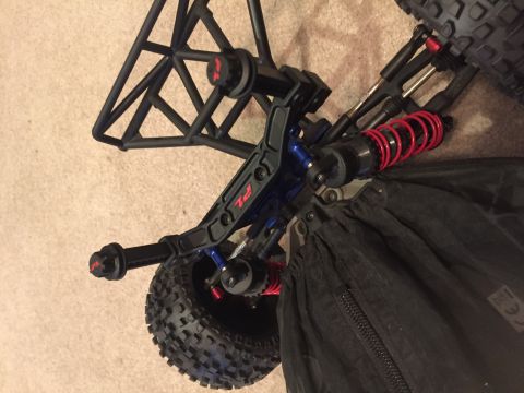 2014 Dodge 1500 - Remote control car suspension system detail with red coilover shocks and a roll cage structure.