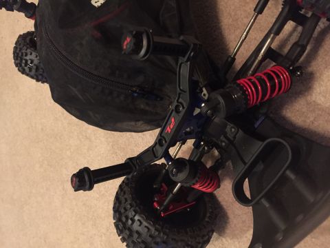2014 Dodge 1500 - Close-up of an RC car's suspension system, red coilover shocks and knobby tires.