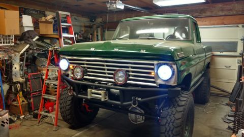 1967 Ford F-250 - Front view of a green 1967 Ford F-250 pickup truck modified with a winch and auxiliary lights.