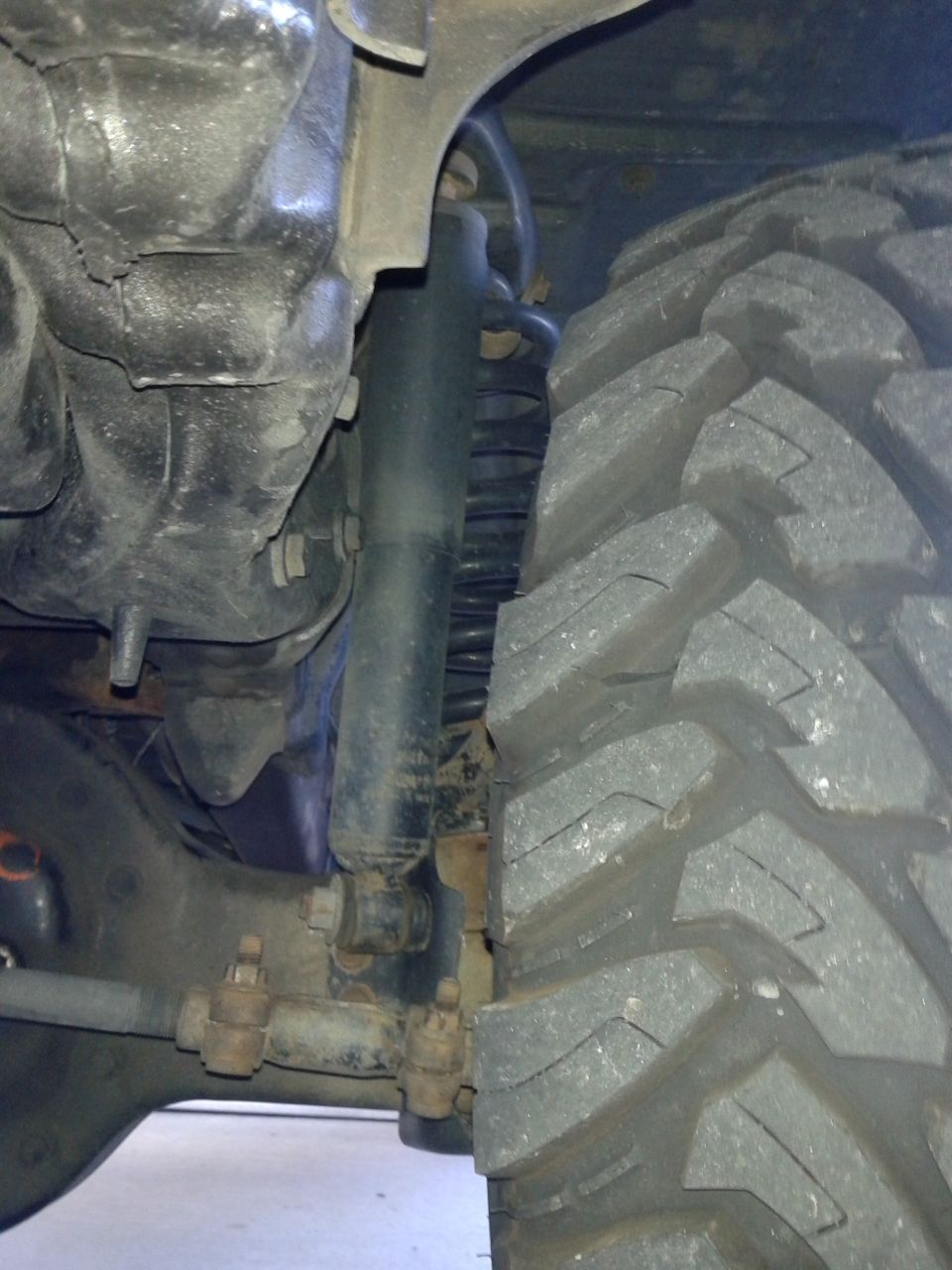 Close-up of a large, knobby tire and suspension components on a vehicle