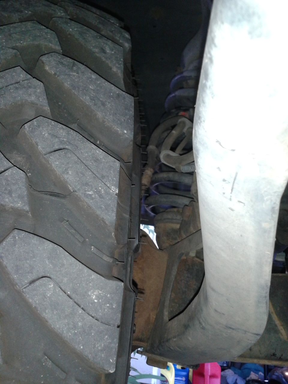 Close-up of a large tire and suspension system