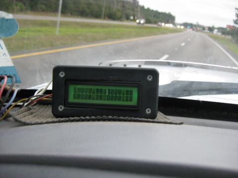 1994 Ford Bronco - A custom digital display is mounted on the dashboard, showing data while driving on a highway.