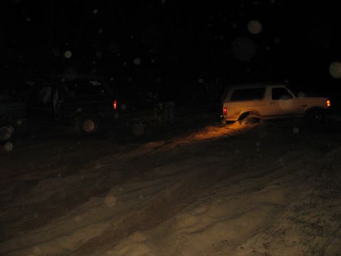 1994 Ford Bronco - Two SUVs navigate sandy terrain at night, with one Bronco appearing to be stuck.