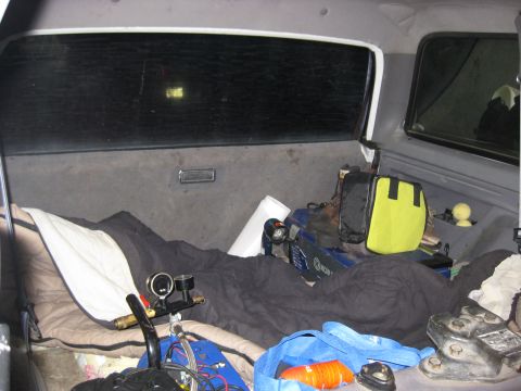 1994 Ford Bronco - Vehicle interior packed with camping gear and sleeping bags, ready for a trip.
