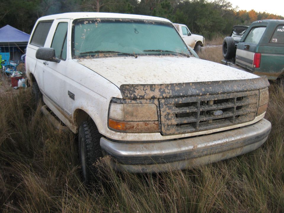 1994 Ford Bronco front 3/4 view, covered in mud