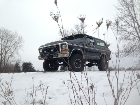 1979 Ford Bronco - A black 1978 Ford Bronco sits on a snowy embankment under a cloudy sky.