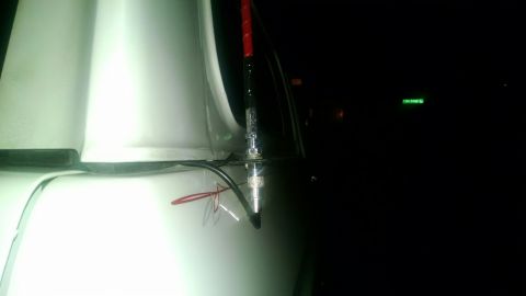 1979 Ford Bronco - Close-up of the antenna mount on a white 1979 Ford Bronco, showing exposed wiring.