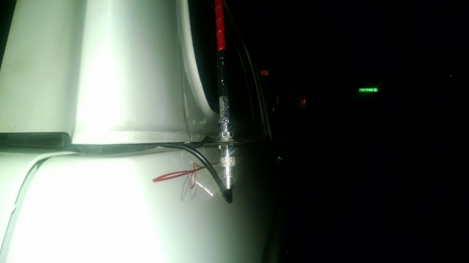 White 1979 Ford Bronco side view with antenna mount and wiring