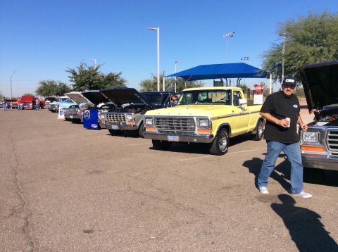1979 Ford Bronco - A line of classic Ford trucks, including a yellow F-Series, are displayed at an outdoor event.