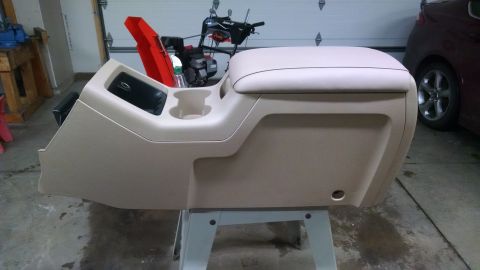 1994 Ford Bronco - A vehicle's center console is shown removed from its original location.
