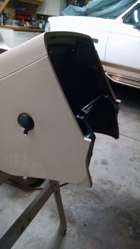 1994 Ford Bronco - Glove box door removed from a vehicle, possibly for repair or replacement.