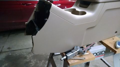 1994 Ford Bronco - A vehicle's center console is shown removed, with tools nearby for modification or after modification.