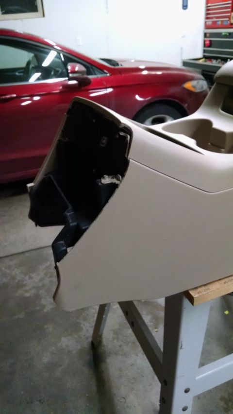 1994 Ford Bronco - Center console part removed from a vehicle, with another car visible in the background.