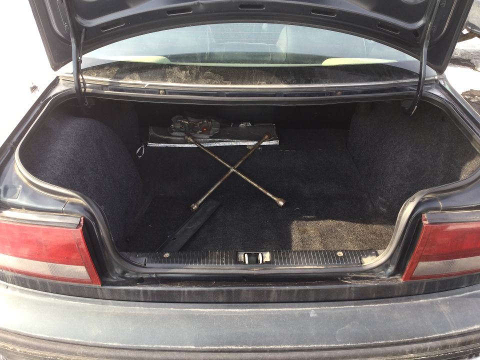 Car trunk interior with spare tire tools and jack