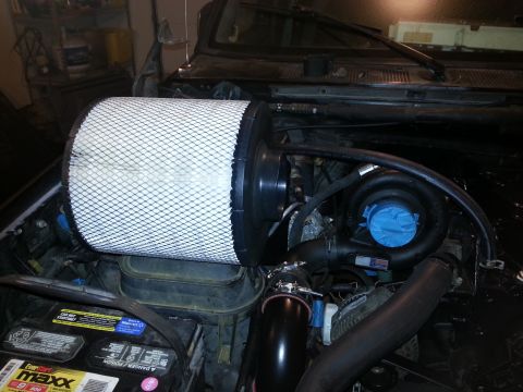 1994 Ford Bronco - Engine bay with a large air filter and turbocharger installed.