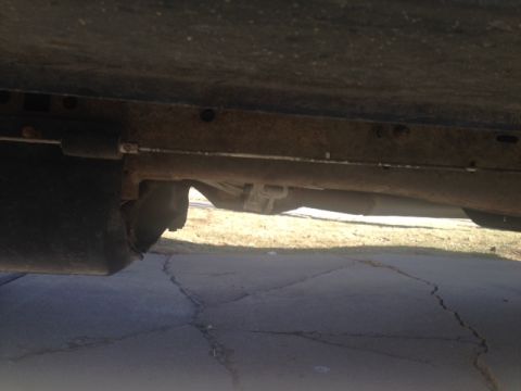 2001 Ford Ranger - The underside of a vehicle shows rust on the frame, exhaust system, and suspension parts.