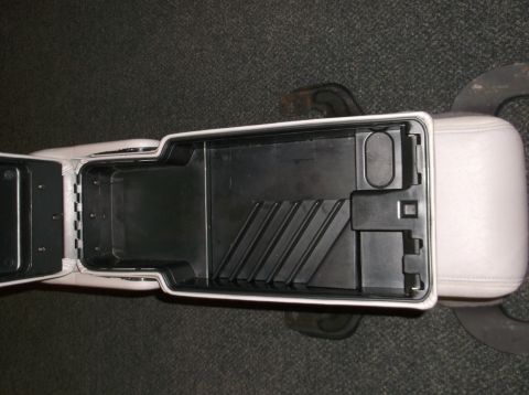 1999 Mercury Grand Marquis - Interior view of an open car center console storage compartment.