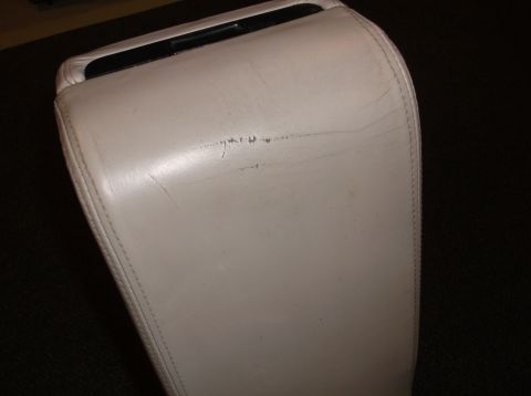 1999 Mercury Grand Marquis - Close-up of a worn car armrest with visible scuffs and stitching.