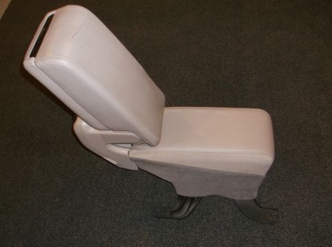 1999 Mercury Grand Marquis - A beige center console armrest is shown from a side angle against a dark carpeted background.