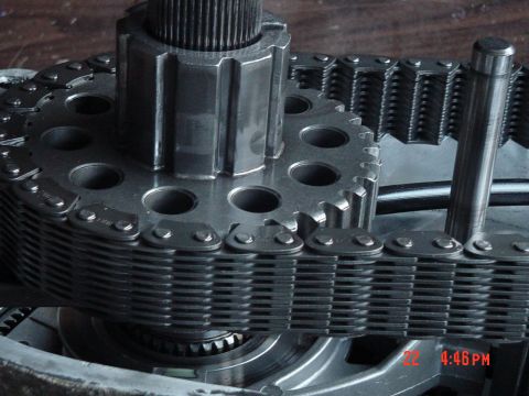 1987 Ford Bronco - Transfer case chain and gears with a splined shaft. Part of a vehicle's drivetrain.