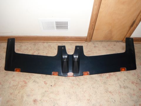 1990 Ford Bronco - Aftermarket truck visor with amber marker lights, likely for a semi-truck.