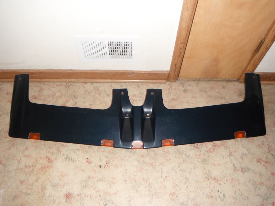 Dark aftermarket truck visor with amber marker lights