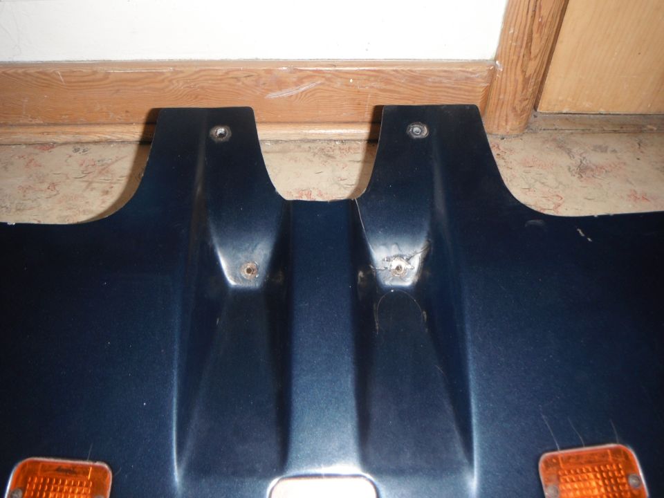 Dark blue plastic panel with two orange lights and mounting holes