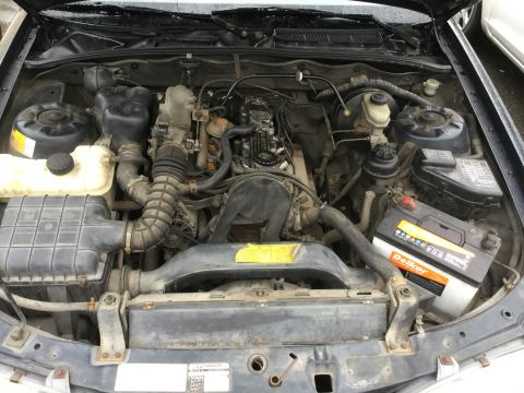 1995 Holden Astra - The engine bay of a vehicle, a Delkor battery and a Supermotors.net watermark.