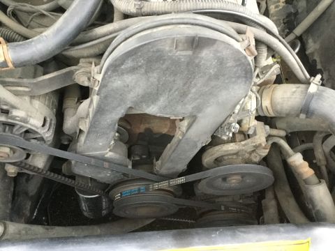 1995 Holden Astra - Close-up view of the engine bay, focusing on the serpentine belt system and air filter housing.