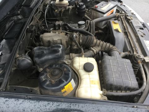 1995 Holden Astra - Close-up view of a car's engine bay, showing various components like the battery and coolant reservoir.