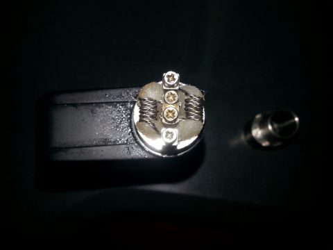 2007 Dodge Durango - A vape coil assembly with cotton wicking and screws is shown against a dark background.