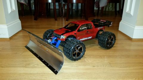 1994 Ford Bronco - A remote-controlled truck is equipped with a snow plow attachment, ready for winter action.