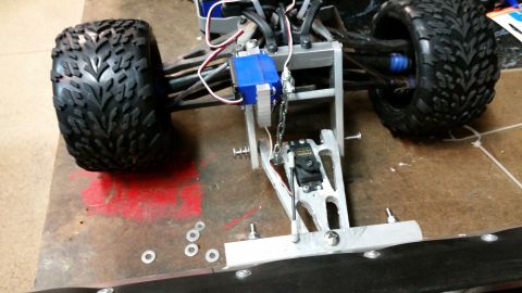 1994 Ford Bronco - Close-up view of an RC car's front chassis, showing its mechanical components and off-road tires.