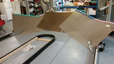 1994 Ford Bronco - Building an RC car track with plywood ramps and a curved section in a garage setting.