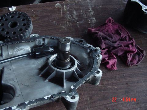 1987 Ford Bronco - Close-up of a transmission component, possibly for a manual swap, with a chain and sprocket visible.