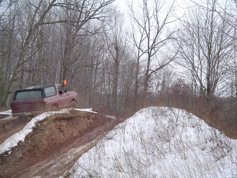 1993 Ford Bronco - A vintage Ford Bronco navigates a challenging off-road course during a winter day.