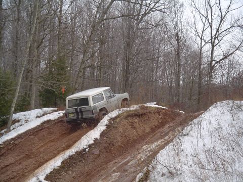 1993 Ford Bronco - A 1993 Ford Bronco navigates a challenging muddy and snowy off-road course.