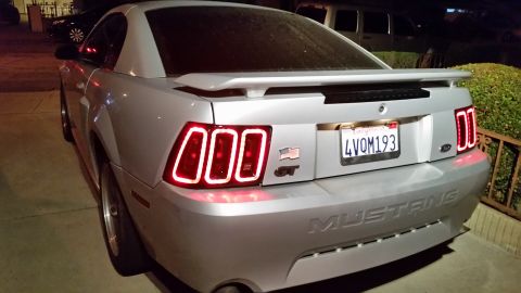 2002 Ford Mustang - Rear view of a silver 2002 Ford Mustang GT custom sequential taillights and a GT badge.