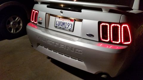 2002 Ford Mustang - The rear of a silver Ford Mustang shows off its updated LED taillights and 'Mustang' badging.