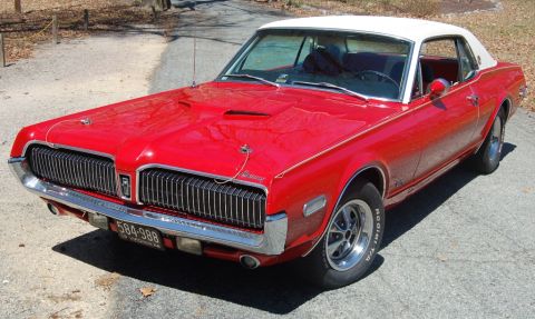 1968 Mercury Cougar - A red 1967 Mercury Cougar with a white roof is parked on a gravel road.