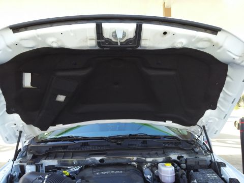 2000 Ford Crown Victoria - The underside of a vehicle's hood is open, revealing the engine compartment and sound dampening material.