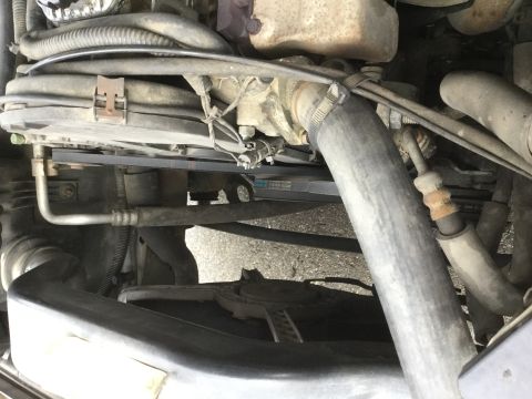 1995 Holden Astra - Close-up view of the engine bay, showing belts, pulleys, and hoses.