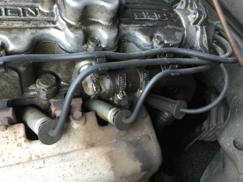 1995 Holden Astra - Close-up view of engine components, including spark plug wires and a portion of the engine block.