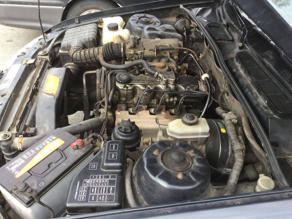 Engine bay with battery and fuse box visible