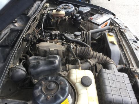 1995 Holden Astra - Close-up view of a vehicle's engine bay, showing mechanical parts and fluids.