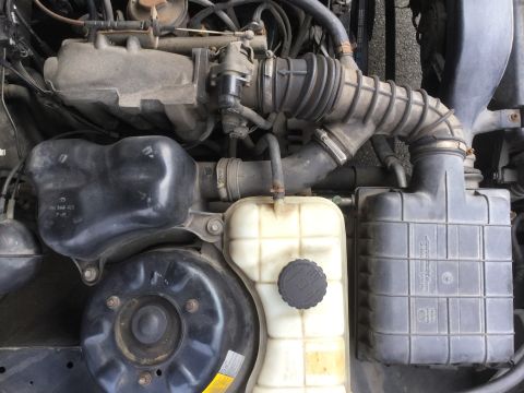 1995 Holden Astra - Close-up view of engine components including the air intake system and coolant reservoir.
